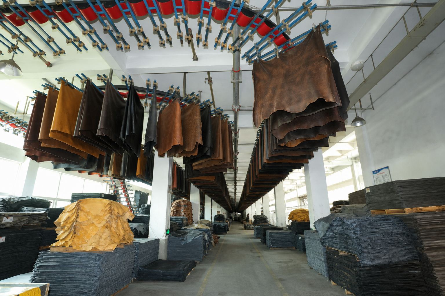 LEBO leather surface film-transfer processing area with hanging cowhide materials before final assembly